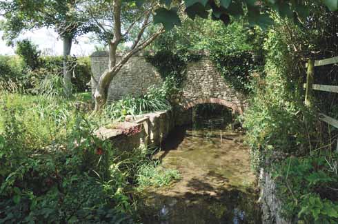 1010edBurton5 Reflecting the industrial past of the village, the mill stream is but one of a number of watercourses running through Burton, which originally takes its name from the River Bride (it was known as Bridetone in Norman times), while Bradstock comes from the Abbey of Bradenstoke in Wiltshire which held the manor from the 13th century