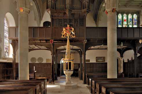 211edWimbStGiles2 The west gallery, in dark oak, houses the organ and has seating for the choir and bell ringers