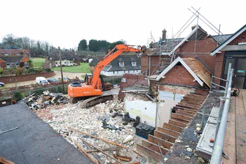 611edWIMBORNE3 The first stage of building with existing outbuildings being demolished to make way