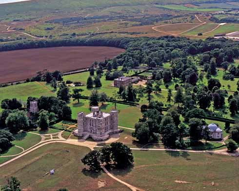 An aerial view of Lulworth Castle. To the left is the parish church of St Andrew, to the right the Roman Catholic Chapel of St Mary. Lulworth Castle House is behind the castle, with the Army ranges in the background.