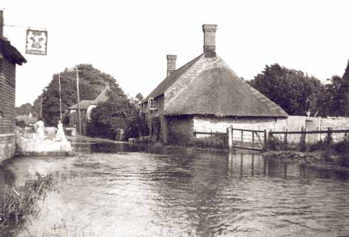 The Brewers Arms in Martinstown in July 1955. The 'road' in the foreground is called Burnside. Martinstown's alternative name is Winterbourne St Martin, although perhaps Summerbourne might be more accurate.