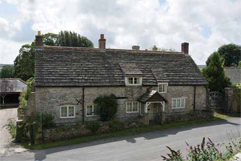 The vernacular stone construction and especially the increasing size of the stone slabs used as roofing are clearly evident on this fine example of a Purbeck cottage