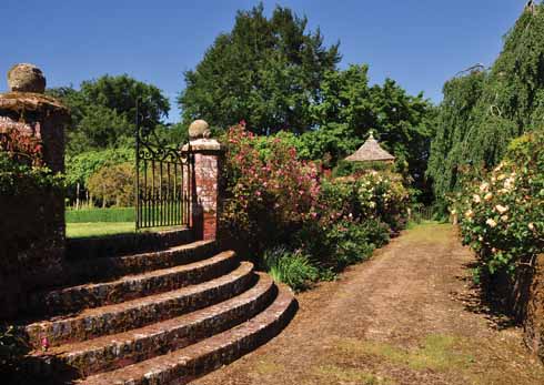 A view along the Ladies’ Walk beside the River Winterborne. Weathered and lichen-covered brick and stone are a soft form of hard landscaping that only comes with clean air and time.