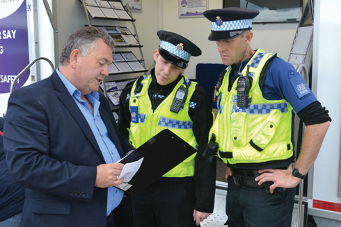 Martyn Underhill with two Police Community Support Officers on the PCC's stand in September last year