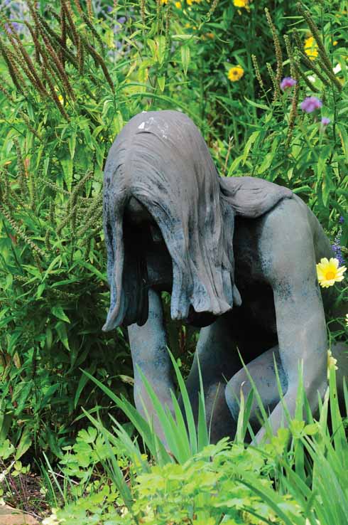 The statue of a young female gardener reminds us of the hard work required to maintain such a high standard.