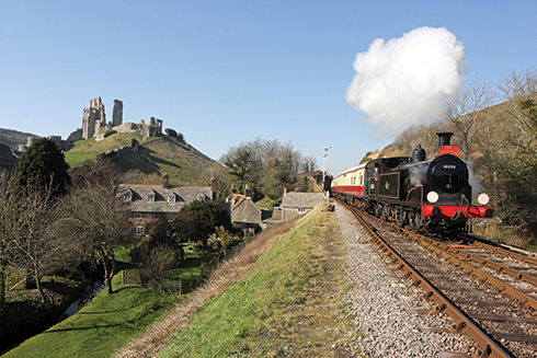 Swanage Railway’s M7 class tank engine No. 30053 hauling a Dorsetman Sunday lunch train, steams past Corfe Castle