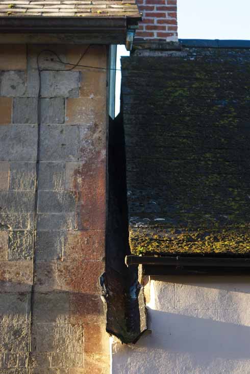 Guttering (or perhaps more precisely gullying) between two mis-matched roof and draining systems on Salisbury Street