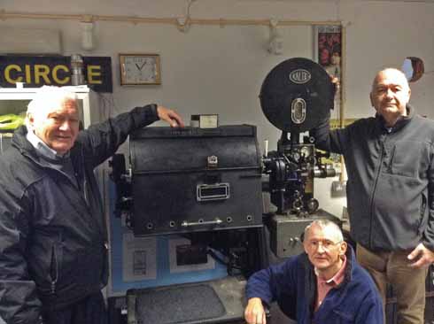 t Bob Dobson, Phil Stevens and John Thornley with one of the vintage projectors which is preserved in the Regent Cinema Museum. The one actually used today is a considerably more sophisticated piece of kit!