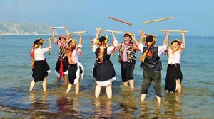 Morris dancers cool their heels with a dance in the sea