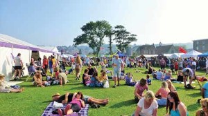 Sandpit Field during Swanage Folk Festival with its bar, marquee, craft field and good folk lazing about in the sun